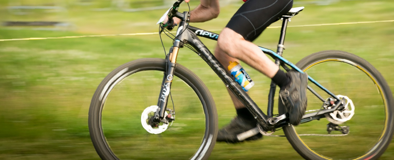 Close up of a person riding a mountain bike.